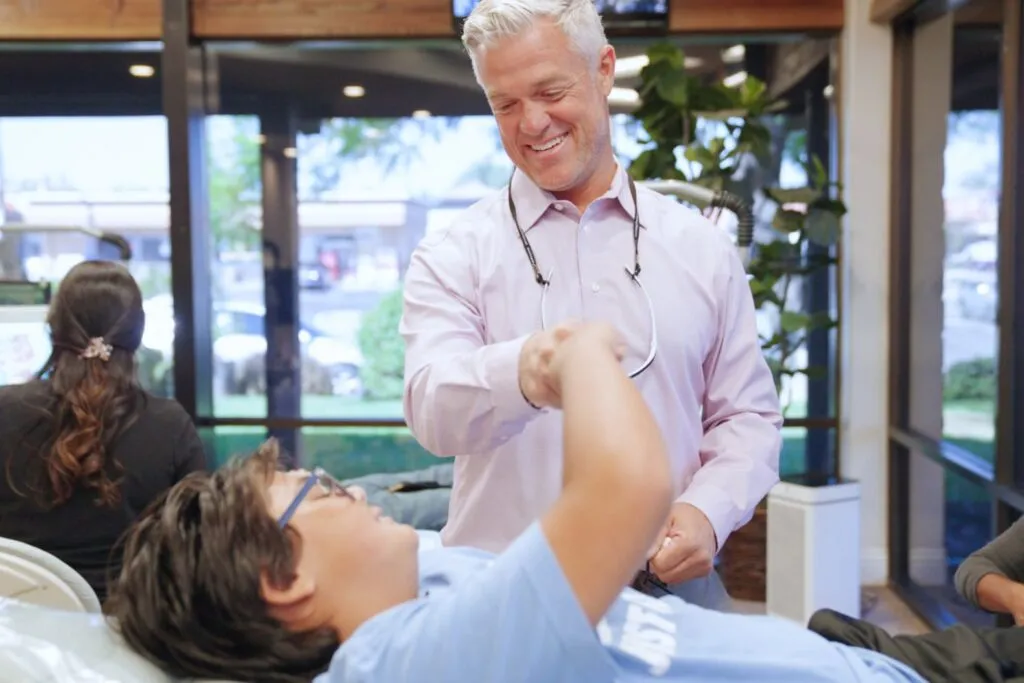 Orthodontist greeting a patient in the treatment bay at Larson Orthodontics