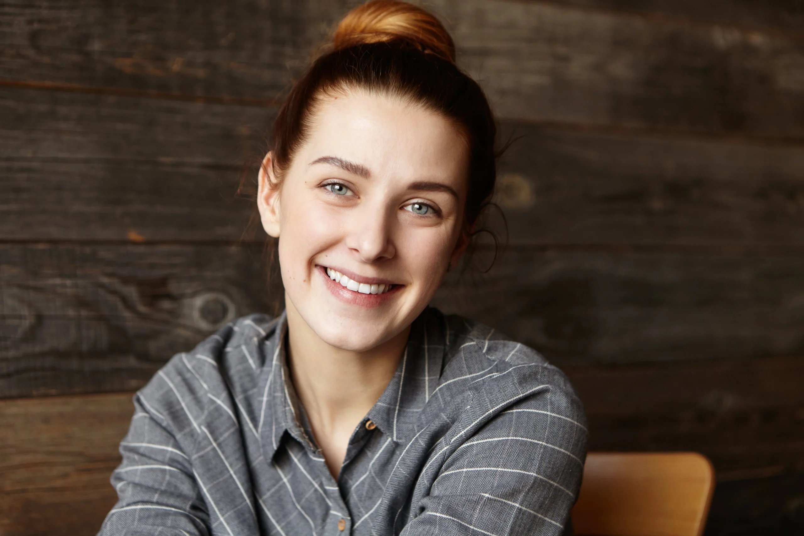 Woman smiling after braces treatment and retainer wear